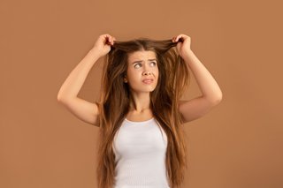 Kobieta przeczesująca swoje długie włosy